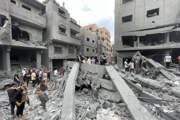Palestinians look for survivors after an Israeli airstrike.