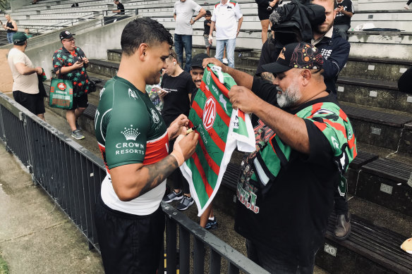 Mr 150: Latrell Mitchell is greeted by his father, Matt, after Souths training on Thursday