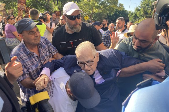 Fred Nile collapses at a rally in Sydney on Saturday.