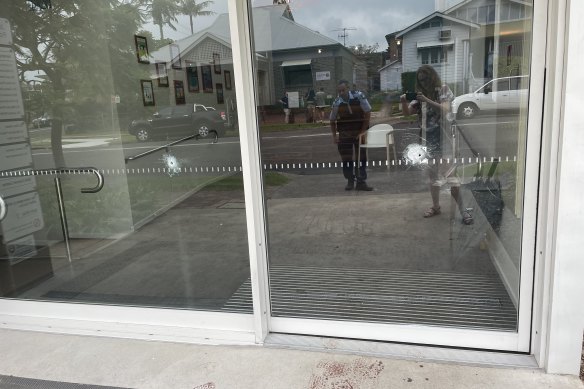 Bullet holes can be seen in the front door of the Junction Street Family Practice on Thursday morning.