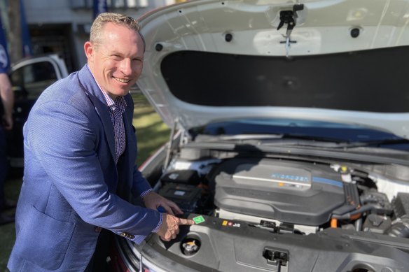 Queensland Renewables and Hydrogen Minister Mick de Brenni checks under the bonnet of a Hyundai NEXO.