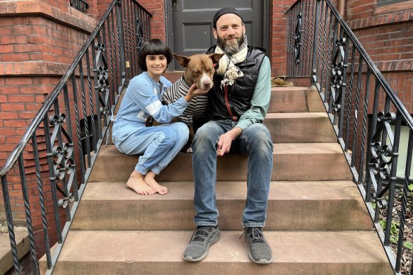 Daniel Adler’s daughter Mango, 11, sitting on the stoop of their Washington home, thinks her father’s protest was “pretty cool”. 