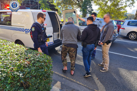 NSW Police making an arrest in Redfern as part of anti-domestic violence Operation Amarok in July. Hundreds are now before the courts as part of the crackdown.