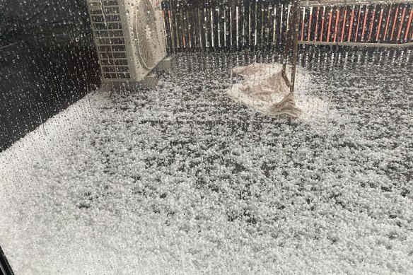 Hail blankets a balcony in Northcote on Saturday. 