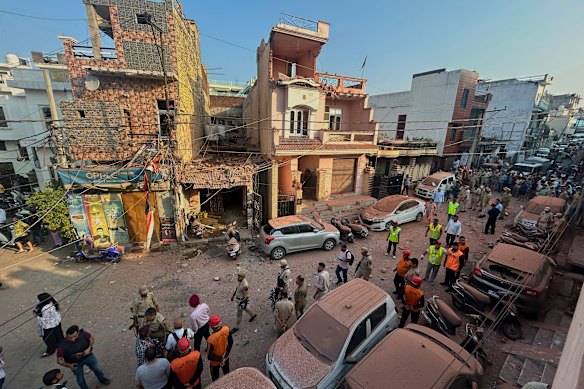 Rescuers and security workers inspect a residential building damaged by a Pakistani drone attack in Jammu, India, on Saturday.