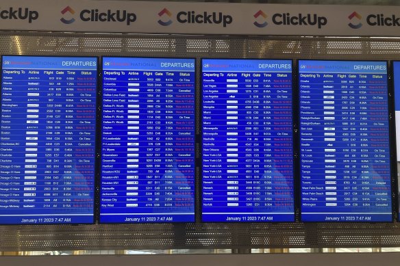 A message board shows departures at Ronald Reagan Washington National Airport in Arlington.