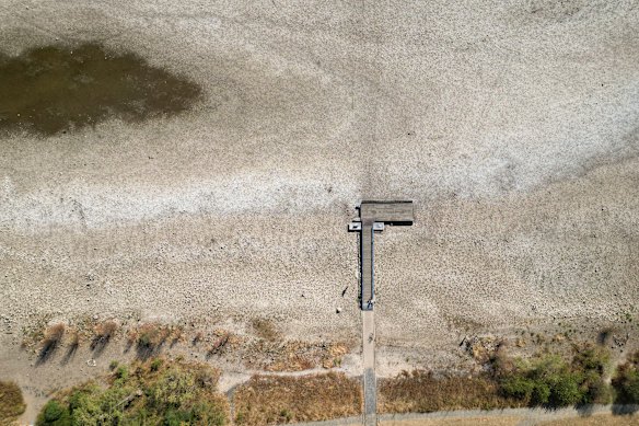 A boat dock surrounded by the dry riverbed of the Rhine, where water levels have reached record lows due to ongoing drought and hot weather.