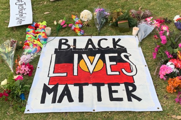 Flowers and a sign in Alice Springs in the days after Kumanjayi Walker was fatally shot by police.