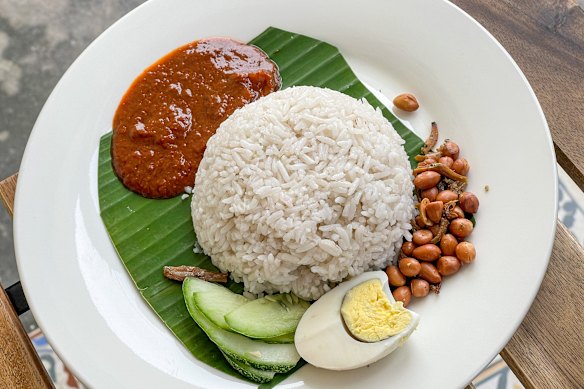 Breakfast of champions … Nasi lemak, Malaysian coconut milk rice, served with egg, sambal, fried crispy anchovies, toasted peanuts and cucumber.