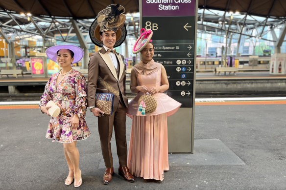 Vilma Riparip, Domingo Martinez and Frelyn Dela-Cruz wait for the train to Flemington Racecourse at Southern Cross Station.