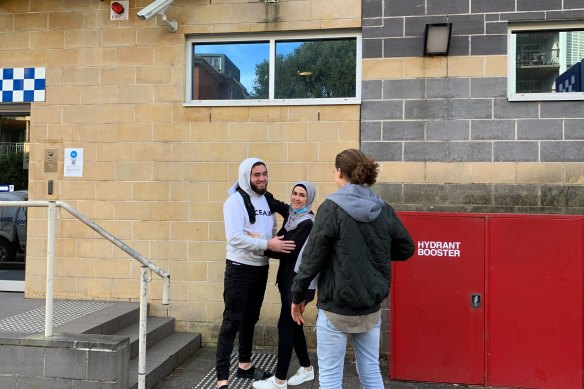 Wassem El Jajieh (left, white hoodie) leaving Burwood police station after getting bail. 