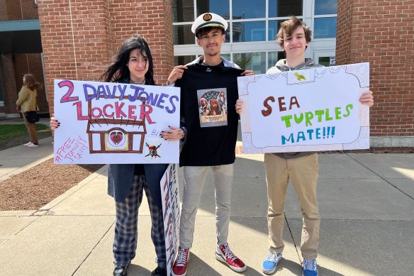 Pirates of the Caribbean fans Hannah Yeahgley, Ethan Diddlemeyer and Nick Lusby outside the Depp’s defamation trial with signs they made to support the actor.