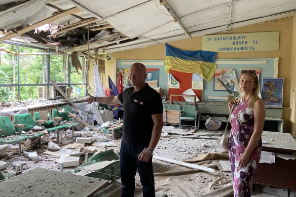 Dmytro Chornyi and Elena Kotovska inspect a holiday camp damaged by the Russian army and being redeveloped as housing in Irpin with the help of Australian aid funding. 