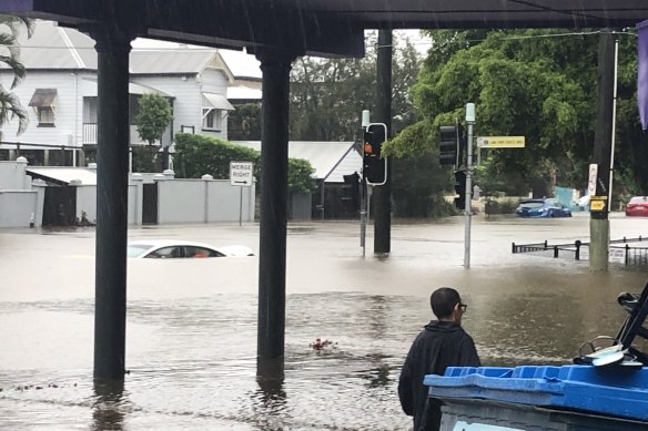 A car is submerged at the intersection of Baroona, Haig and Fernberg roads in Paddington on Saturday morning.  