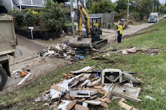 Crews and householders clear flood damage in St Lucia.