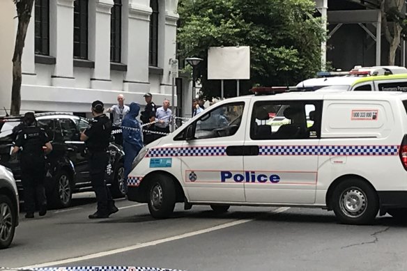 Forensic officers examined the scene near Quest apartments, opposite the Westin Hotel.
