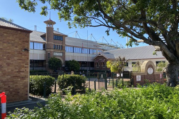 The red-brick, heritage-listed buildings at East Brisbane State School. The Gabba looms large over the school.