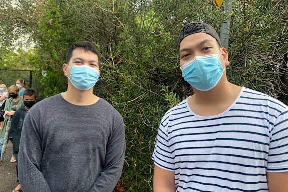Justin Salvador, right, and his brother John in line for a COVID test in Caringbah on Thursday, 