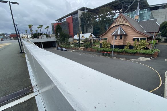 The redeveloped Suncorp Stadium awkwardly dwarfs the heritage-listed 1891 Christ Church in Milton.