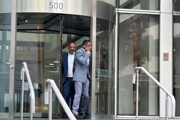 Yung Filly - real name Andres Felipe Valencia Barrientos, in the grey suit - leaves court after the first day of his trial on Monday.