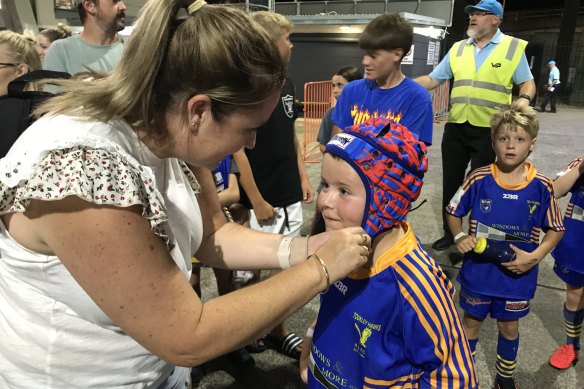 Holli and her son Andy with Kalyn Ponga’s headgear.