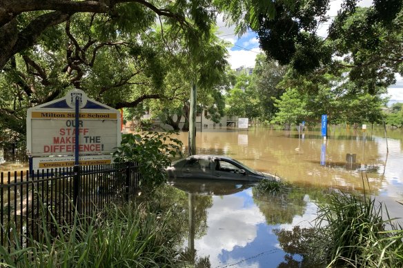 Cars are submerged next to Milton State School in Brisbane’s western suburbs.