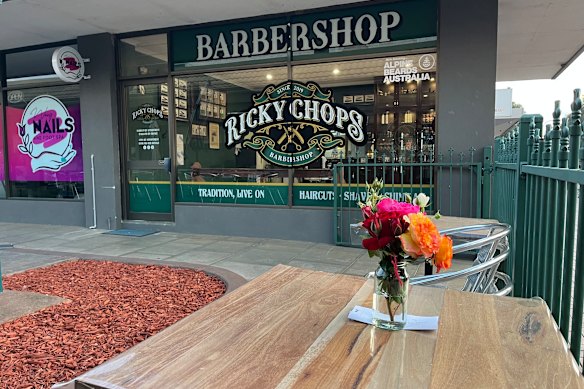 Flowers rest out the front of Ricky Jefferies’ barbershop in Wangaratta on Tuesday morning.