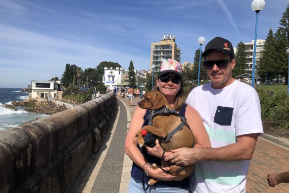 John and Stacey Wilson, of Hillsdale, with dog Cooper at Coogee Beach on Easter Monday.