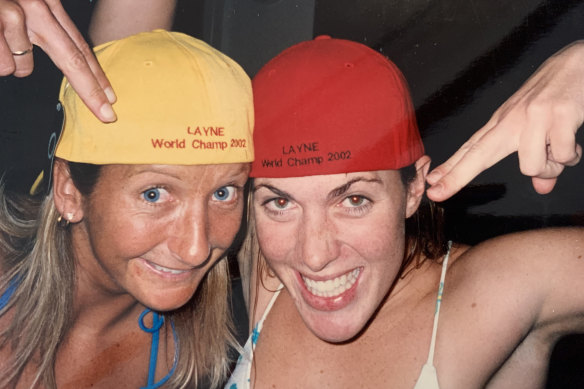 Farris (at right) with world champion Layne Beachley in 2001 (amused by their caps, which were mistakenly printed with the year 2002).