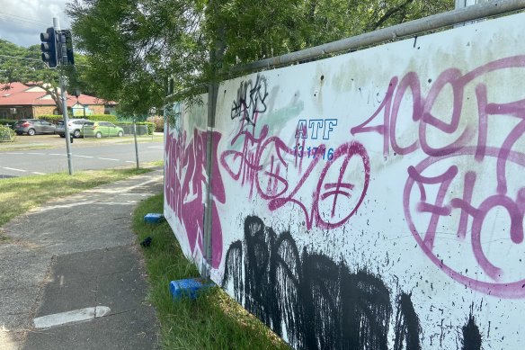 A small portion of graffitied boarding remains at the site of the Yeronga PDA. Until recently, the perimeter fencing on Park Road was wrapped in disintegrating bunting. 