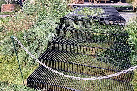 Grasses erupting below open stairs in a display by Distinctive Gardens 