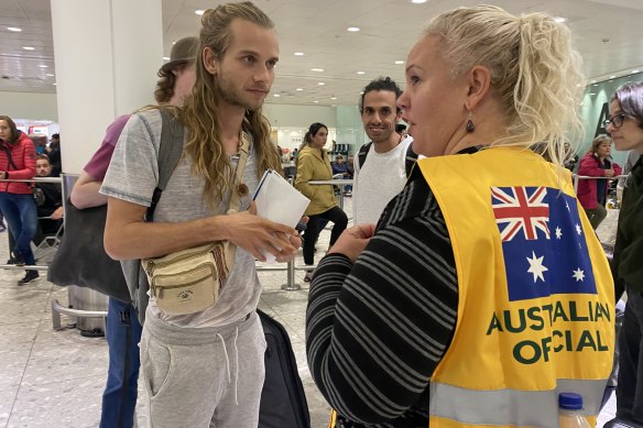 Australian embassy staff greet people off the plane from Tel Aviv in London.