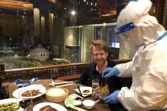 A waiter serves dinner to The Australian’s North Asia correspondent Will Glasgow inside the Beijing Olympic bubble. 