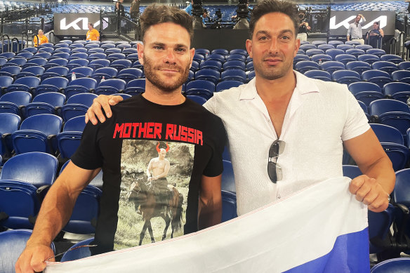 Russian fan Eugene Routman (left) and his friend Duran Raman pose for a photo following Daniil Medvedev’s match on Monday night.