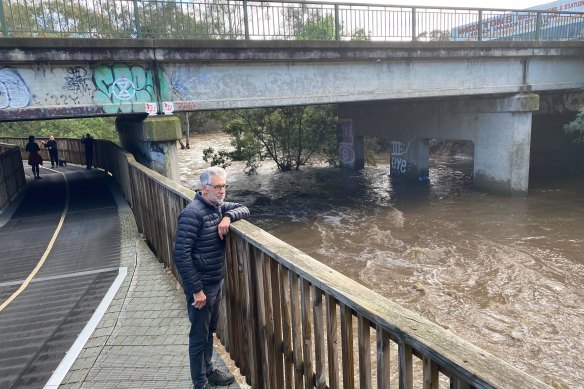 Locals watch the floodwaters rise on the Merri Creek in October 2022. 