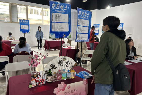 Graduates look for work at a job fair in Beijing. 