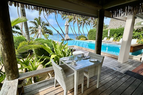 Tables are scattered around the infinity pool.