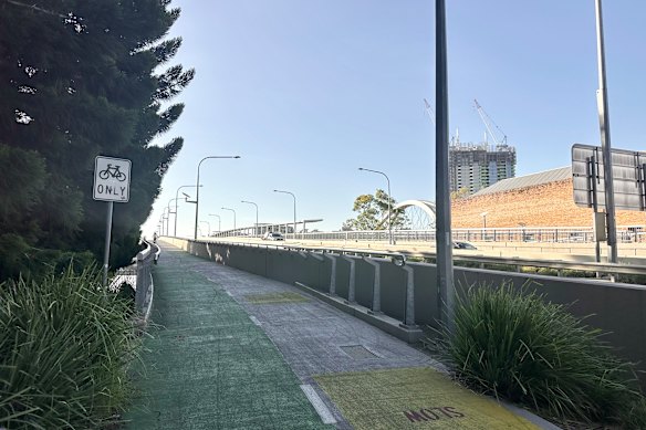 An example of a two-way separated path, with a bicycles-only sign, across the Go Between Bridge. The pedestrian-only path is on the other side of the bridge.