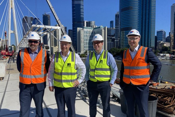 Labor senator Anthony Chisholm, Brisbane’s LNP lord mayor Adrian Schrinner, Brisbane councillor Ryan Murphy and Watpac chief executive Mark Baker inspect final concreting on the $300 million Kangaroo Point Bridge.