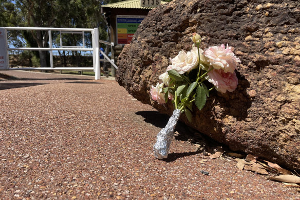 A bouquet of roses has been placed at the entrance to popular Perth Hills swimming destination Lake Leschenaultia in solemn tribute to a teenager who drowned at the site on Tuesday.
