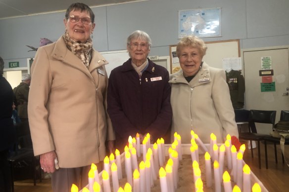 War widows Dianne Holyrood, 91, Avis Tilley, 98, and Maureen Matthews, 85, commemorate the centenary of Legacy at Korumburra, south Gippsland, on Sunday. 