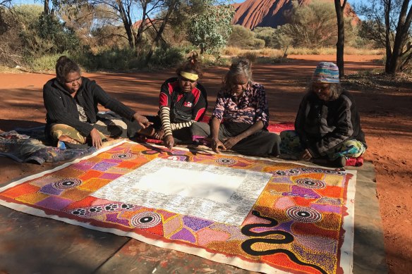 Artists complete their work on the Uluru Statement of the Heart in 2017. 
