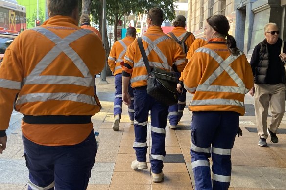 Off the job: Cross River Rail workers in the CBD on Wednesday morning.