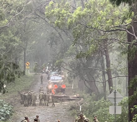 ADF personnel clear the road to Lamington National Park after ex-tropical cyclone Alfred hit.