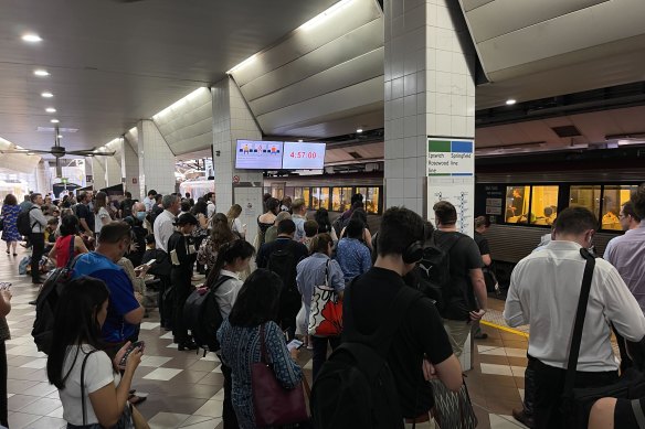 People crowd the platform at Central Station after lightning caused a signal fault and created commuter chaos in Brisbane in December. 