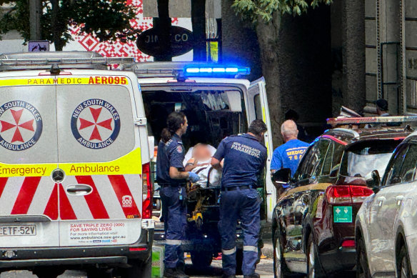 Paramedics treat a man after a shooting on Castlereagh Street in Sydney’s CBD.