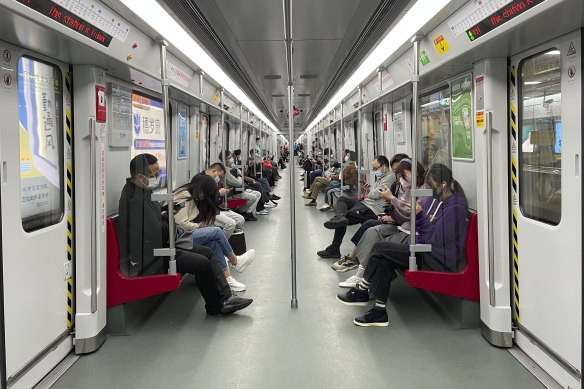 Residents take public transportation in Haizhu District as pandemic restrictions are eased in south China's Guangzhou Province.