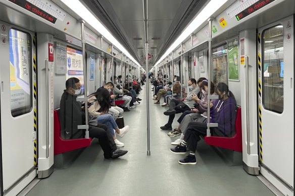 Residents ride public transport in the district of Haizhu as pandemic restrictions are eased in southern China’s Guangzhou province.