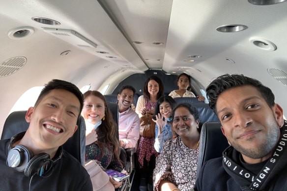 Ooi and Thillainadarajah with the Nadesalingam family on a plane.
