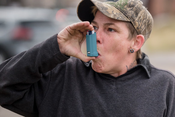 Moo Blake takes a dose of an inhaler. Blake was diagnosed with bronchitis due to chemical fumes after the spill.